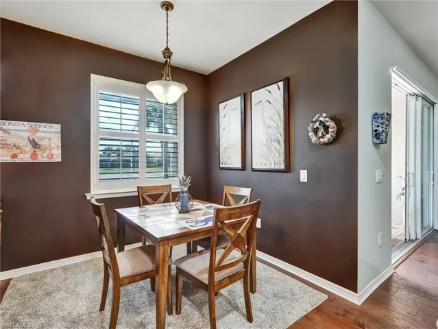 Dining area with baseboards and hardwood / wood-style floors