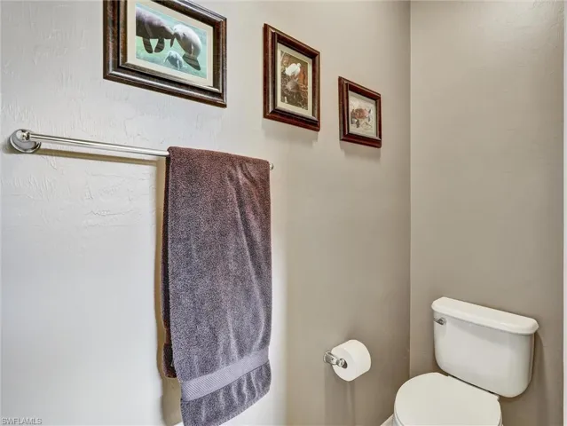 Bathroom with toilet and a textured wall