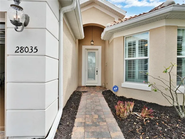 Property entrance with stucco siding and a tile roof
