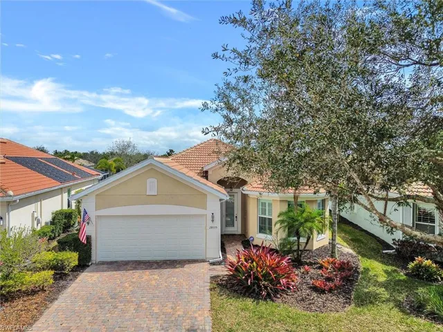 View of front of property with stucco siding, a garage, and decorative driveway