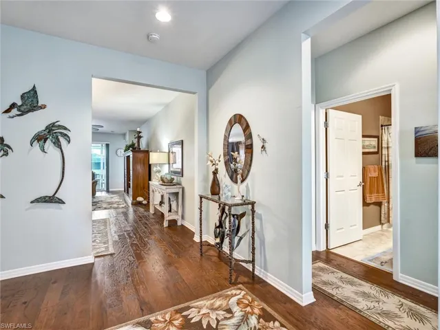 Hallway with dark wood-style floors and recessed lighting