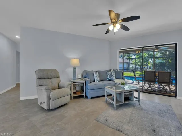 Living room featuring baseboards and ceiling fan