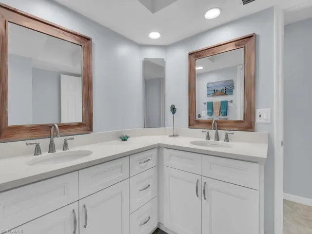 Full bathroom featuring double vanity and recessed lighting