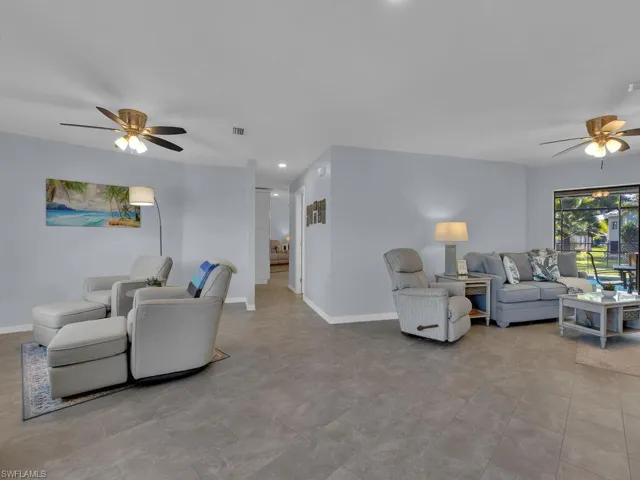 Living area featuring a ceiling fan and recessed lighting