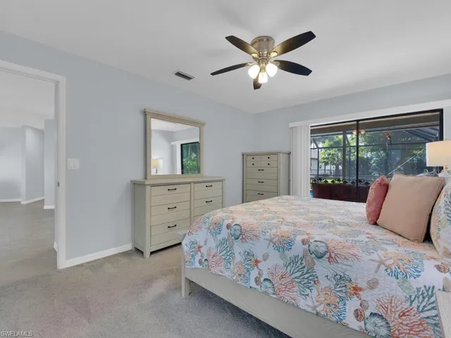 Carpeted bedroom featuring access to exterior and a ceiling fan