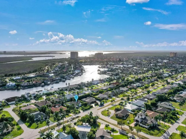 Aerial view of property's location featuring a large body of water and nearby suburban area