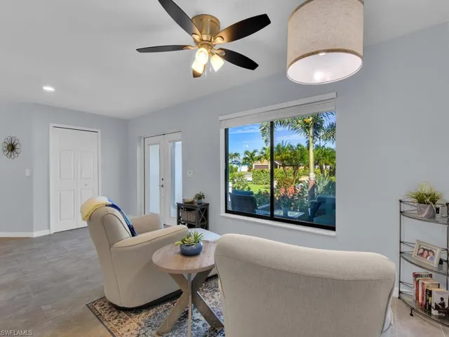 Living room with recessed lighting, ceiling fan, and french doors