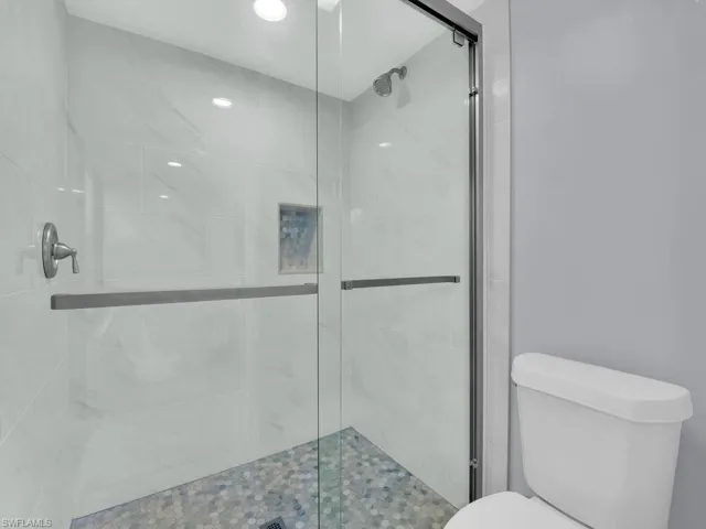 Full bathroom with a shower stall