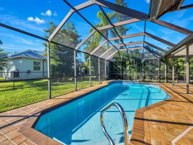Outdoor pool with a patio area, a sunroom, and a lanai