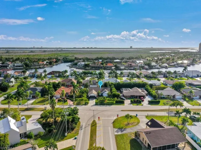 Aerial view of residential area featuring a large body of water