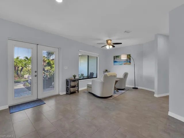 Living room featuring french doors and a ceiling fan