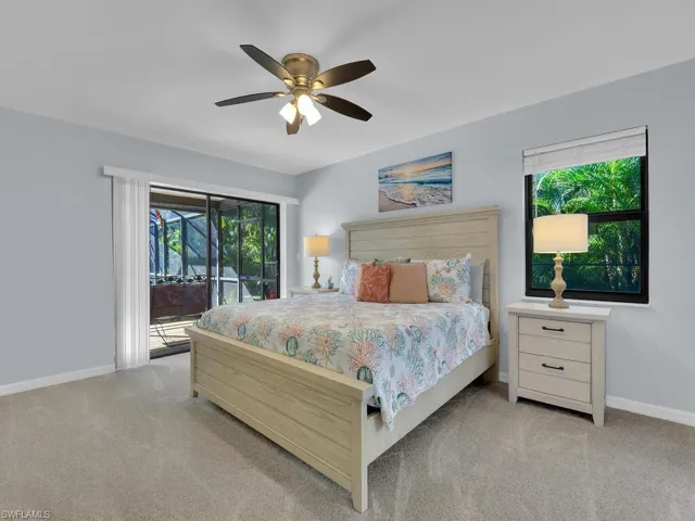 Bedroom featuring access to exterior, ceiling fan, and light colored carpet