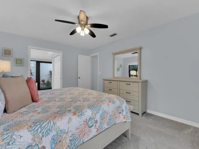 Bedroom with light carpet and ceiling fan