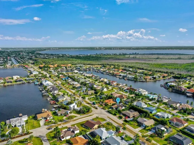 Aerial view of property's location with nearby suburban area