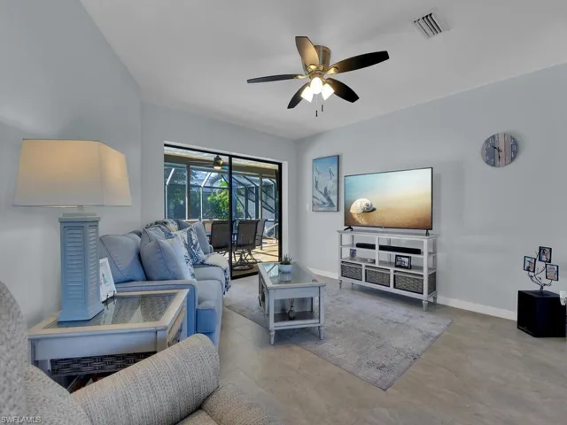 Living room with a ceiling fan and a sunroom