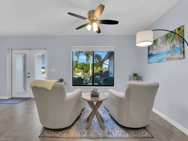 Living area featuring ceiling fan and french doors