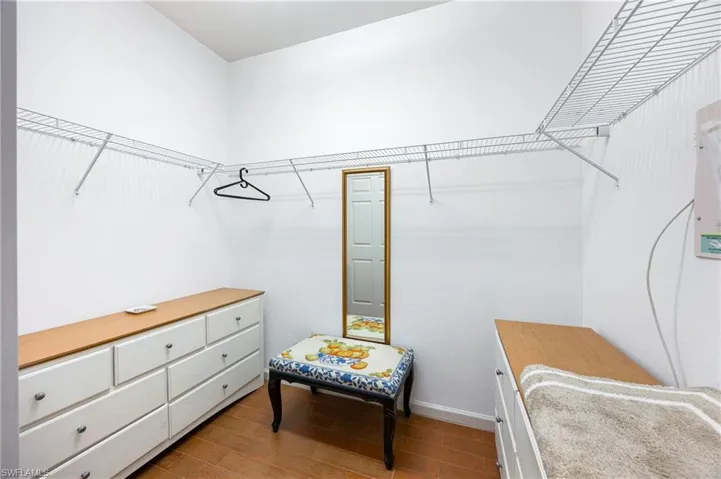 Spacious closet with dark wood-style floors