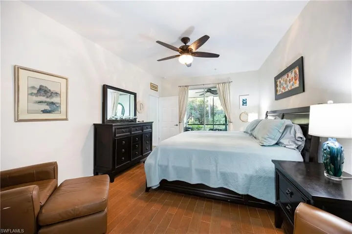 Bedroom with dark wood-type flooring and ceiling fan