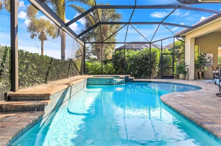 Pool and Spa with water features and a picture window screen.