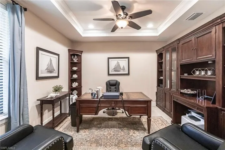 Office with crown molding, ceiling fan, recessed lighting, and more.