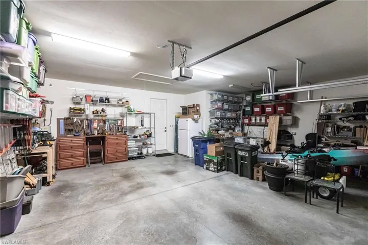 3-car Garage featuring  a garage door opener and pull down stairs to attic.