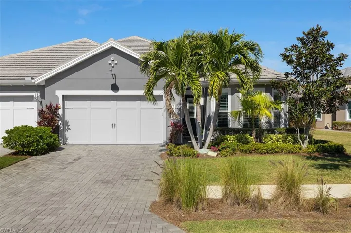 View of front of home featuring a garage and a front yard