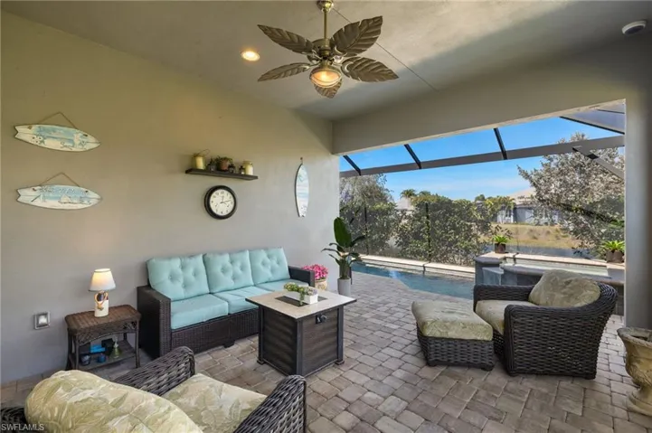 View of patio with an outdoor living space, a lanai, and ceiling fan