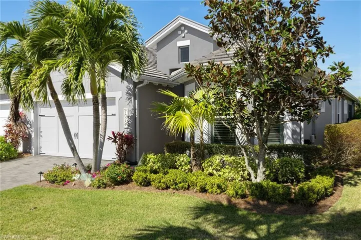 View of front of house with a garage and a front yard