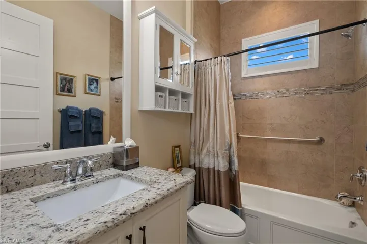 Full bathroom with vanity, toilet, and shower / bath combo