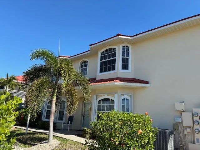 View of side of home featuring stucco siding and a cooling unit