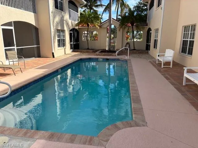 Community pool featuring a patio and a sunroom