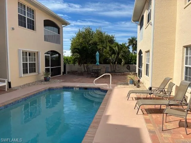 View of swimming pool with a patio, a balcony, and a fenced backyard