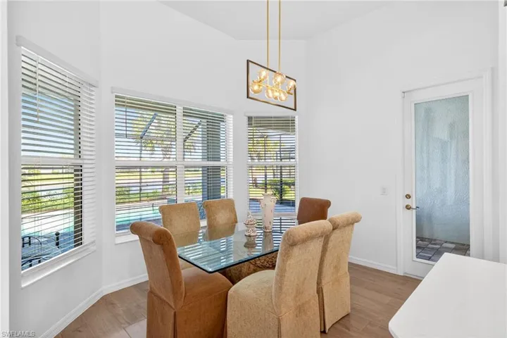 Dining room with wood finished floors and a chandelier