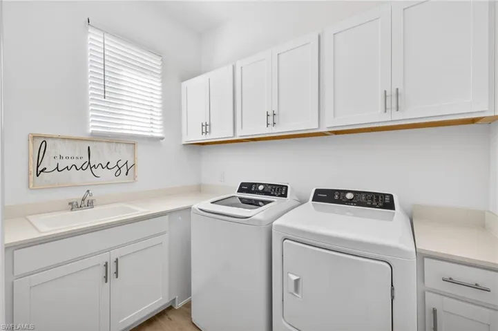 Washroom with cabinet space and independent washer and dryer