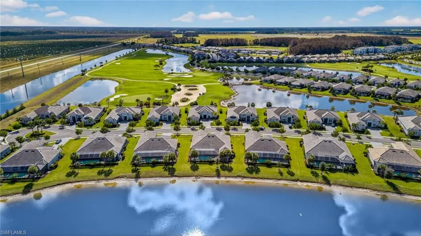 Aerial view of residential area featuring a nearby body of water