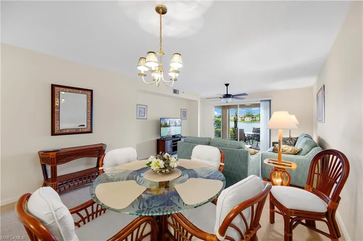 Carpeted living area with a water view and a ceiling fan