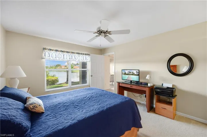 Bedroom featuring light carpet and ceiling fan