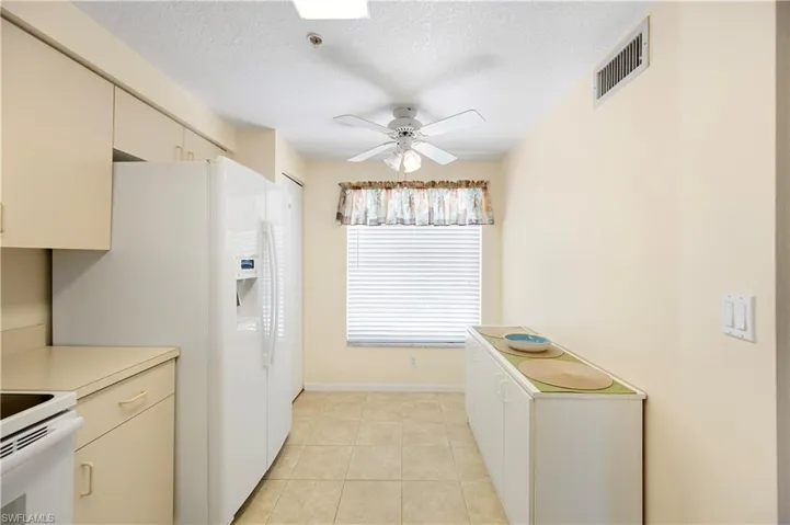 Full bath featuring shower / bath combo, vanity, and a textured ceiling