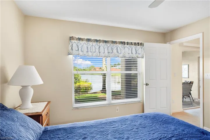 Bathroom with a closet, double vanity, a stall shower, a textured ceiling, and light tile patterned flooring