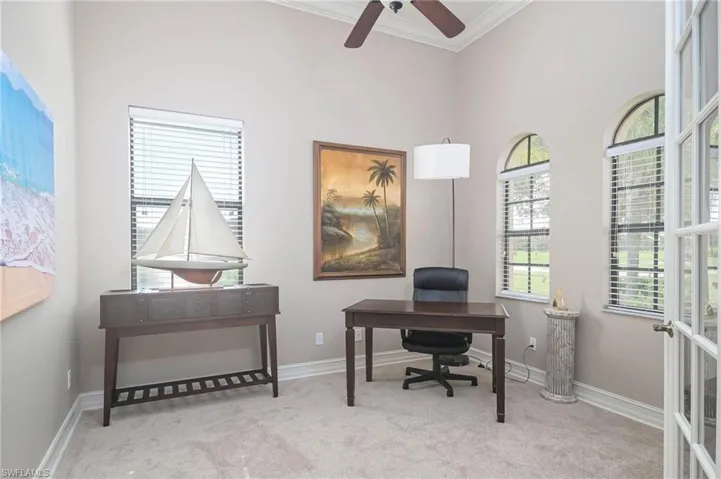 Home office featuring a towering ceiling, ornamental molding