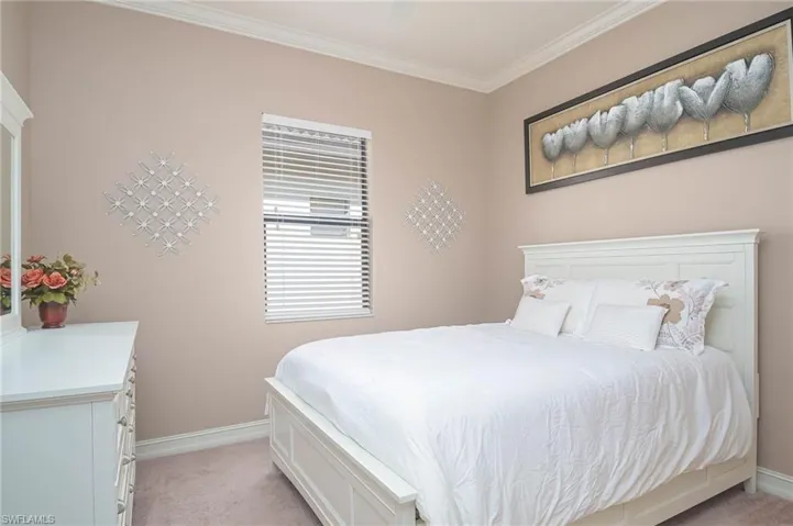 Bedroom featuring crown molding and light colored carpet