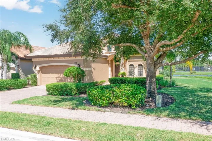 View of front of home featuring a front yard and a garage