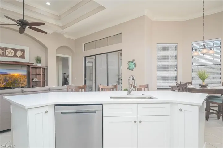 Kitchen featuring white cabinets, sink, and stainless steel dishwasher