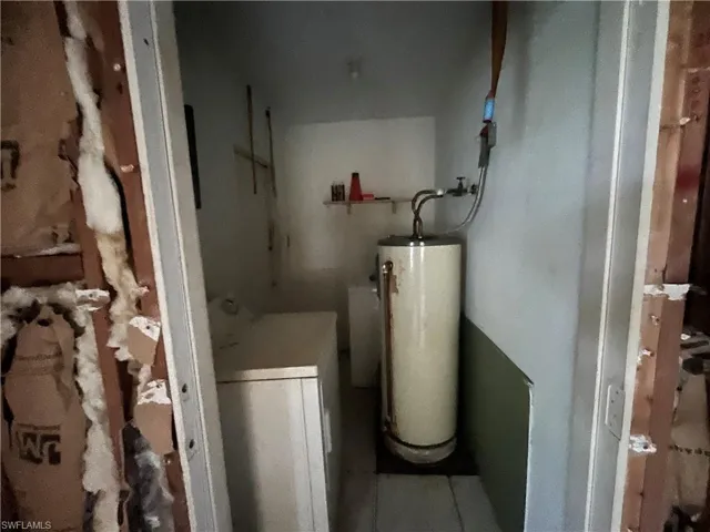 Utility room featuring water heater