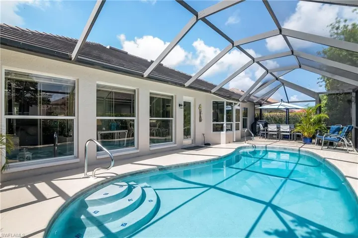 View of swimming pool featuring a lanai and a patio