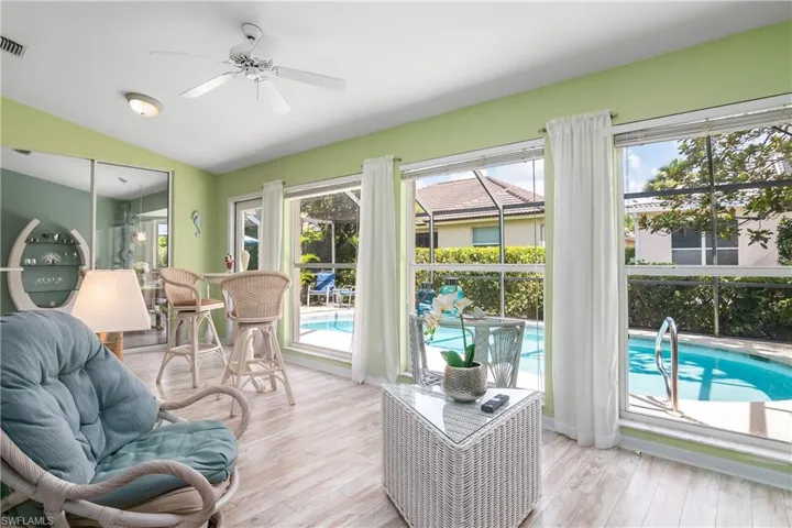 Sunroom / solarium with ceiling fan and vaulted ceiling