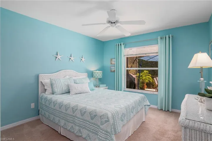 Carpeted bedroom with ceiling fan