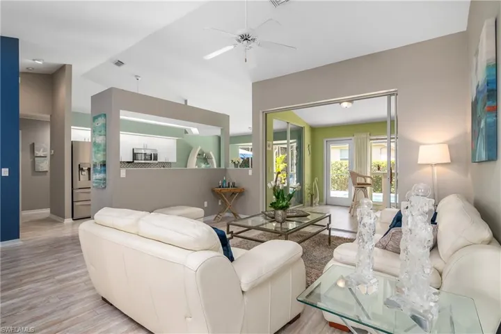 Living room with ceiling fan and light wood-type flooring