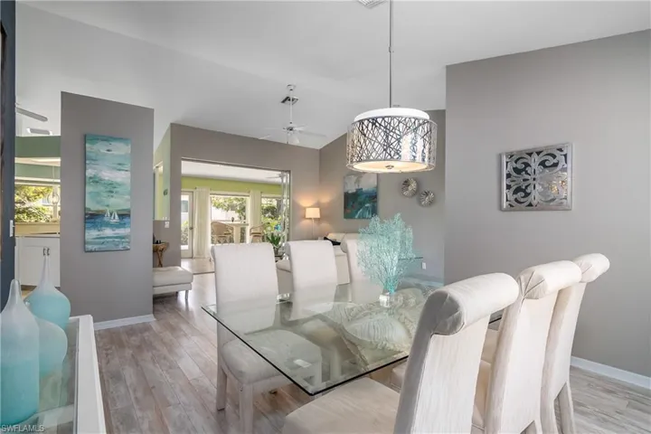 Dining room with ceiling fan and light wood-type flooring