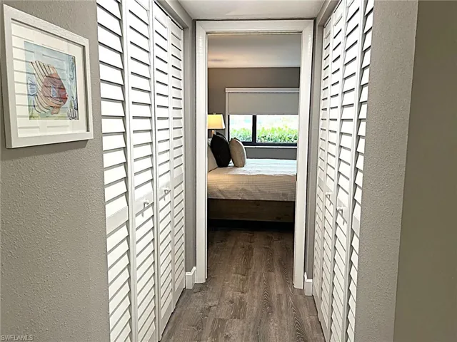 Hall featuring dark wood-type flooring